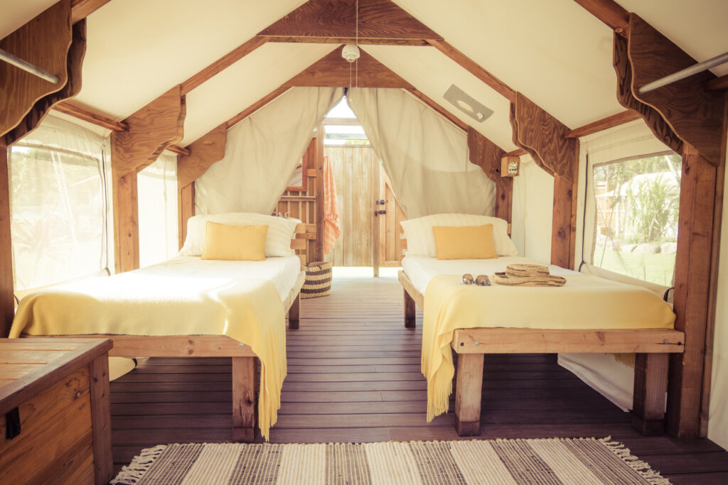 Warm wood and canvas hospitality interior with twin beds