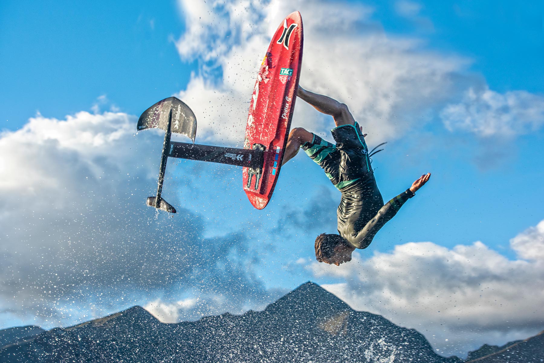Foil surfer rotating above a wave with MFC equipment